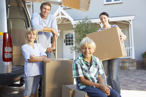 Professional movers handling furniture and packing for a local house move